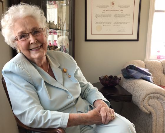 Hon. Marion Reid sitting in her living room, N. MacPhee, 2018