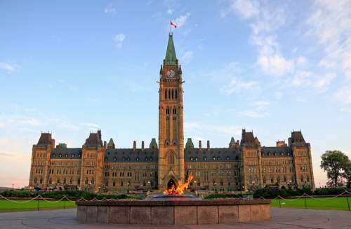 Parliament Buildings with Centennial flame in foreground, Ottawa, Canada