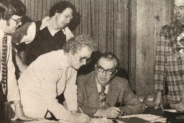Black and white image of Marion Reid signing her nomination papers